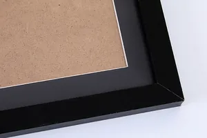 Close-up detail of a minimalist black picture frame with white mat for scratch art