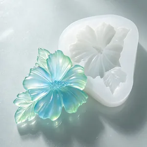 Detailed view of DIY hibiscus flower silicone mold with finished gradient resin charm