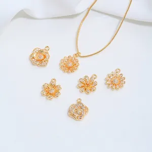 Detailed macro view of 14K gold-plated flower pendants with sparkling cubic zirconia inlays