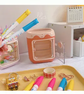 Detail view of a cute mini-fridge shaped stationery organizer with colorful markers and pens.