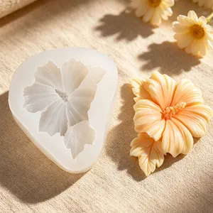 Close-up view of a detailed hibiscus flower silicone mold with finished resin sample