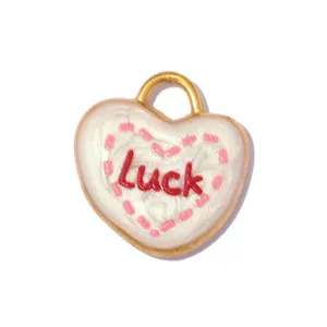 Detail view of white heart-shaped stainless steel pendant with Luck inscription