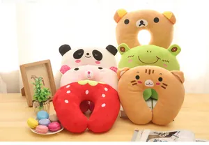 Collection of various cute cartoon animal plush neck pillows displayed on a cozy desk setting