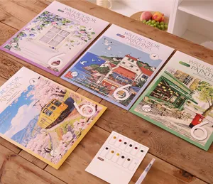 Detailed view of creative watercolor painting set with four books and pigment palette