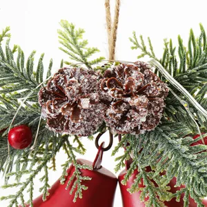 Festive Christmas hanging ornament with warm LED lights, red bells and snowy pinecones