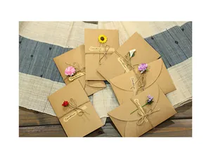 Handmade vintage kraft paper greeting cards with various dried flowers and twine detail