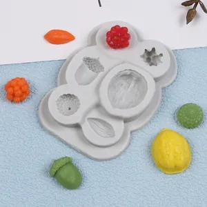 Detail of gray silicone mold showing nut and leaf shapes with colorful samples