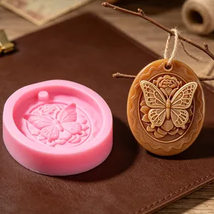 Close-up of pink oval silicone mold and butterfly rose aroma wax tablet