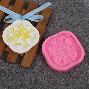 Detailed view of a pink floral silicone mold with a finished white gypsum pendant