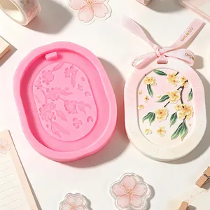 Vista dettagliata dello stampo in silicone ovale a fiori e della targhetta in gesso decorata