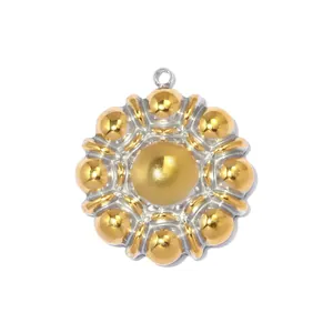 Detail of two-tone stainless steel sun pendant with gold beads in a flower design.