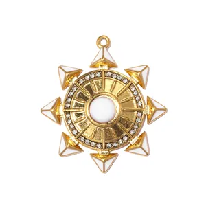 Gold sunburst pendant with white enamel points and clear crystal accents for DIY jewelry.