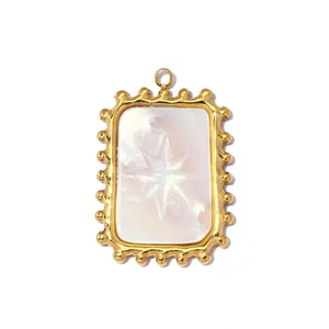 Detail view of rectangular white shell pendant with star engraving and gold beaded frame