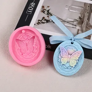 Detailed view of oval silicone mold with butterfly and rose pattern for aroma stone