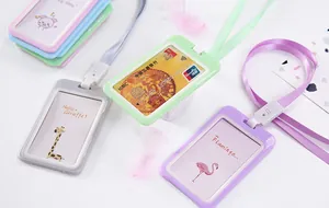 Macro detail view of various colorful plastic ID card holders with cute cartoon inserts and lanyards