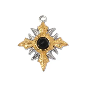 Detail view of a two-tone stainless steel sun cross pendant with a black center stone.