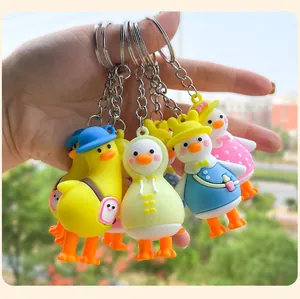 Macro view of adorable cartoon duck keychains with various colorful outfits and bags