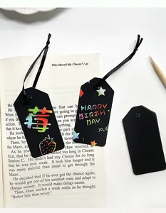 Close-up of DIY scratch art bookmarks with rainbow colored designs on black tags.