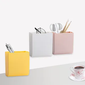 Set of 3 wall-mounted plastic stationery organizers in yellow, white, and pink hues.