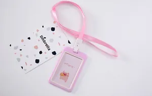 Detail view of pink cartoon ID card holder with matching ribbon lanyard for students