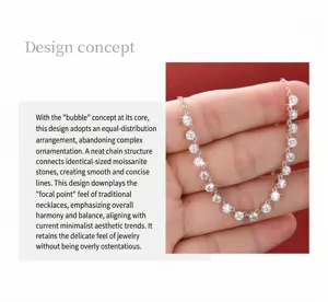 Macro view of a minimalist moissanite bubble necklace in silver finish held by hand