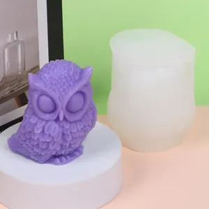 Detail showing a white silicone mold next to a purple owl candle for DIY craft projects
