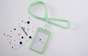 Macro view of a light green cartoon lanyard ID card holder with a cute stick figure.