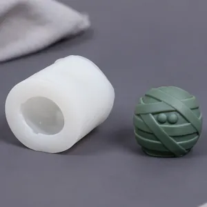 Detail showing mummy ball silicone mold and finished green mummy wax candle piece