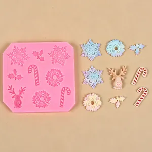 Detailed view of pink Christmas silicone mold with finished snowflake and reindeer pieces