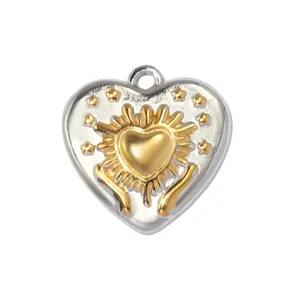 Detailed view of a two-tone stainless steel heart pendant with sunray and star engravings