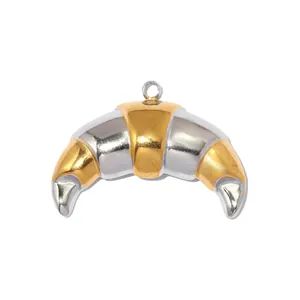 Detail view of a two-tone gold and silver stainless steel croissant pendant for DIY jewelry.