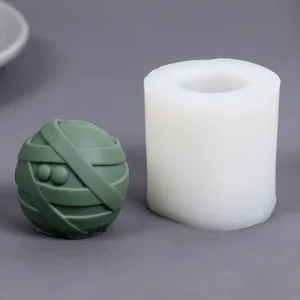 Detailed view of a bandage mummy ball silicone mold with its finished green candle