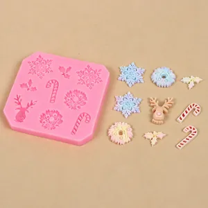 Christmas themed silicone mold with finished fondant snowflakes, reindeer and candy canes