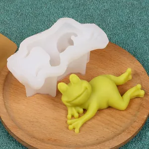 Detailed view of DIY frog shaped silicone mold with a green resin frog figurine