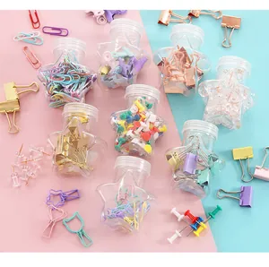 Detail view of pastel office supplies set in star-shaped clear plastic jars