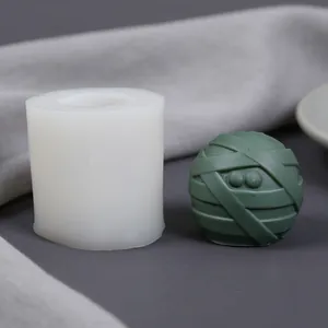 Detail showing bandage mummy ball silicone mold with finished green resin sample