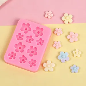Macro view of pink flower silicone mold with finished colorful clay ornaments on a bright backdrop