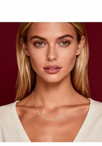 Detailed close-up of a sparkling moissanite smile necklace on a professional model