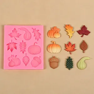 Close-up of the pink silicone mold with autumn harvest leaf and pumpkin shapes for DIY baking