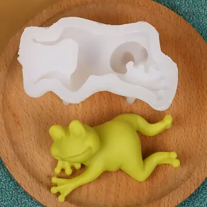 Macro view of a frog-shaped silicone mold showing the detailed mold and finished wax figure.