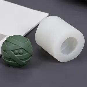 Detail shot of a DIY mummy ball silicone mold and finished green bandage sphere