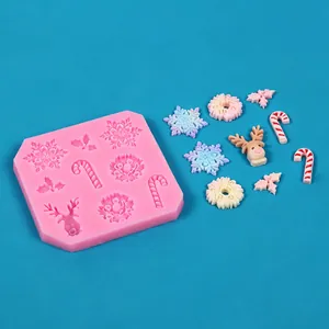 Detailed view of pink Christmas silicone mold with snowflakes, reindeer, and candy cane shapes