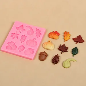 Pink silicone mold with autumn-themed maple leaf, pumpkin, and acorn shapes for DIY cake decor