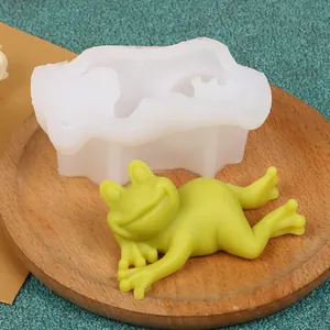 Detailed view of the cute frog silicone mold with a finished green wax frog model on a tray