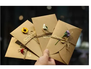 Retro kraft paper greeting cards with handmade dried flowers and natural twine tie.