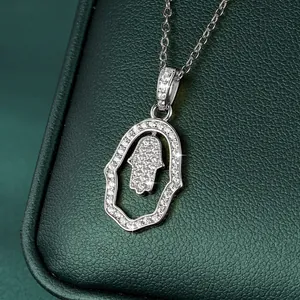 Exquisite close-up detail of a silver Hamsa hand pendant necklace with sparkling pavé crystals