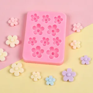 Close-up detail of a pink flower silicone mold with decorative clay floral accessories