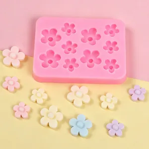 Detailed view of pink flower silicone mold with various pastel clay flower samples