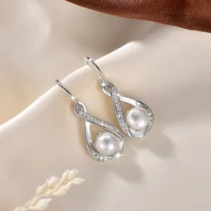 Detailansicht eleganter Infinity-Perlenohrringe mit glänzenden Moissanit-Akzenten
