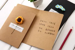 Detail view of open vintage kraft paper greeting card with dried sunflower decor